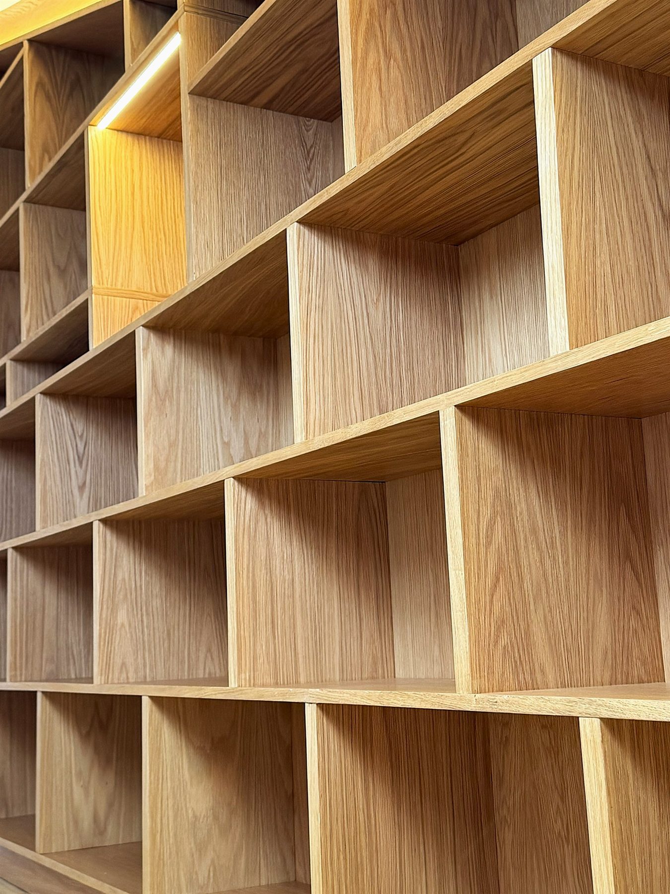 Oak veneer ply bookcase detail with a softly lit display niche