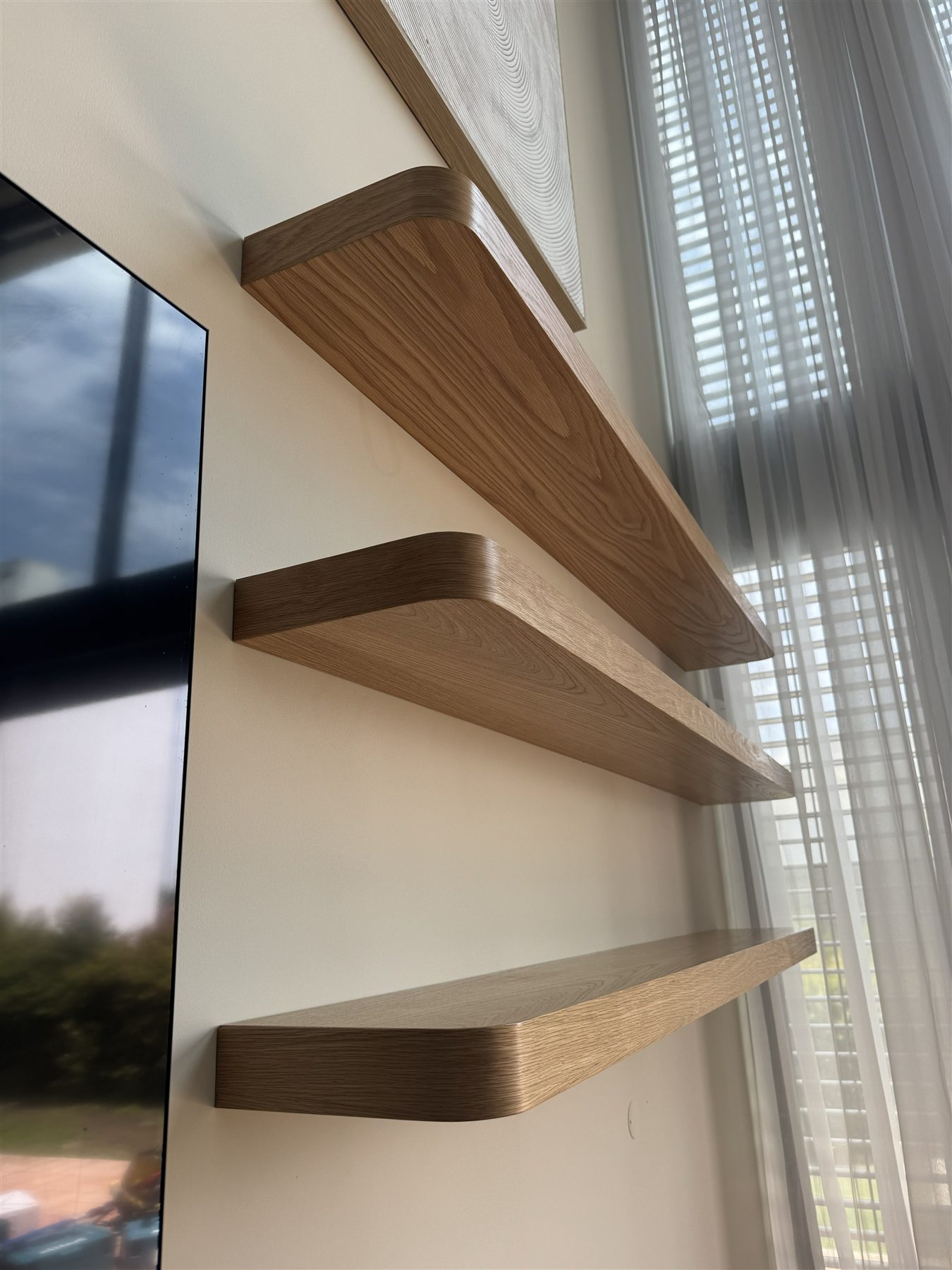 Oak floating shelves with softly rounded ends