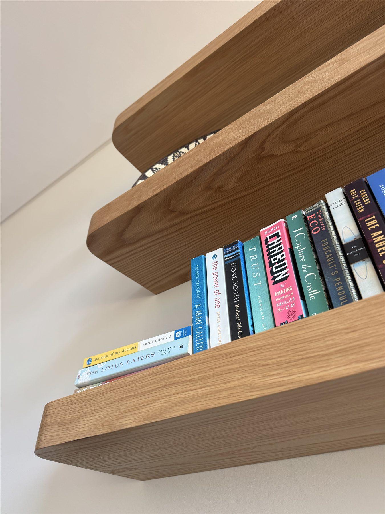 Floating oak shelves styled with books